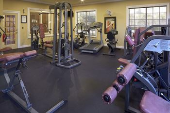 A room filled with lots of different types of exercise equipment